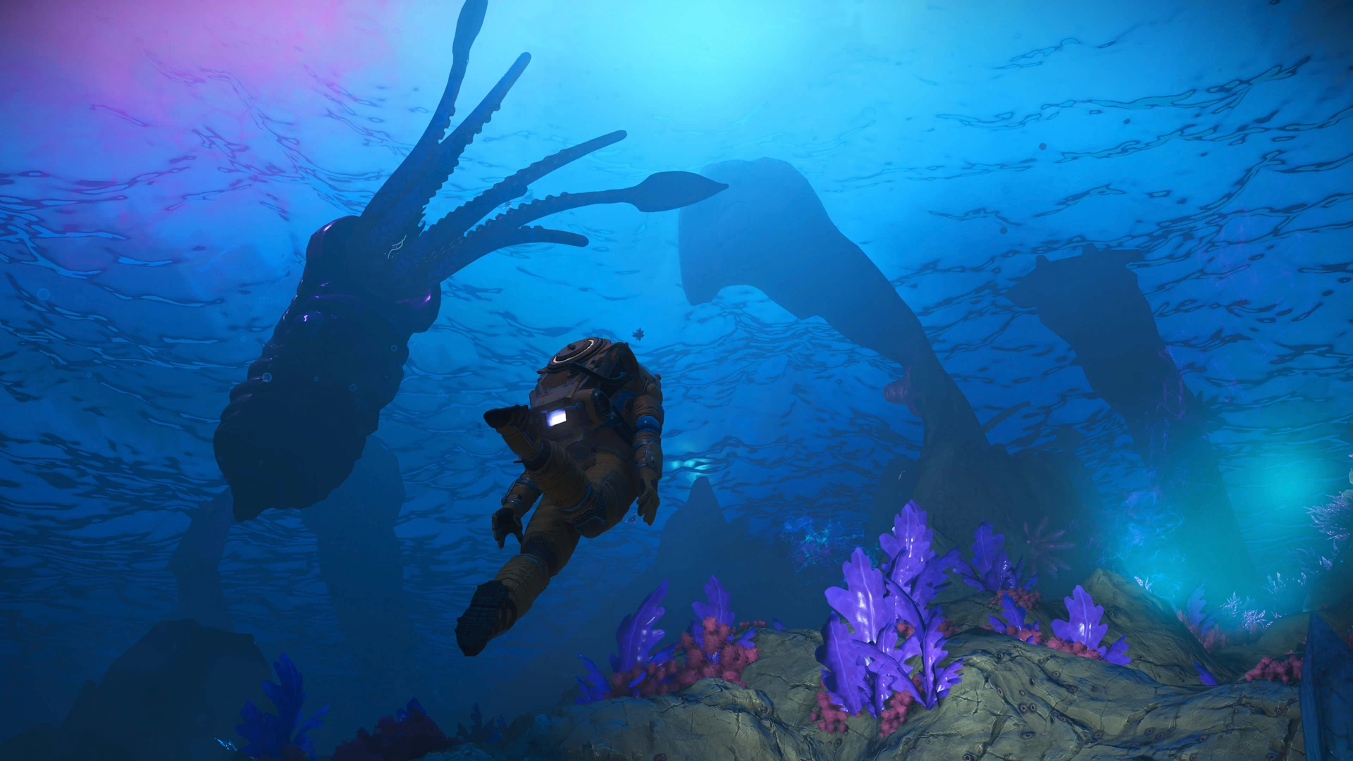 An astronaut swims through deep blue water past purple coral while huge, shadowy sea creatures loom overhead.