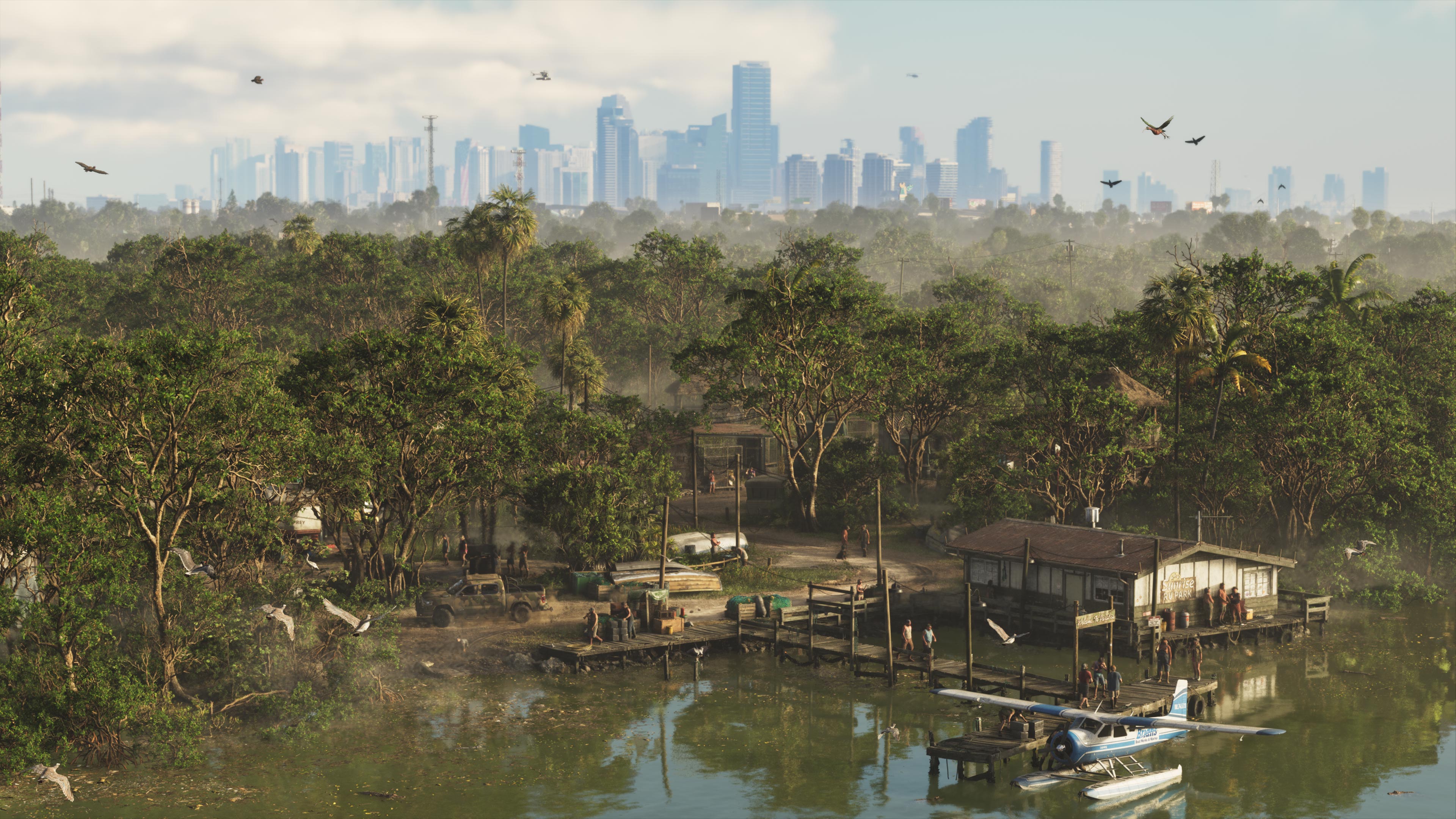 Dense green wetland with stilt houses and a small seaplane at a dock, and the city skyline far off in the haze.