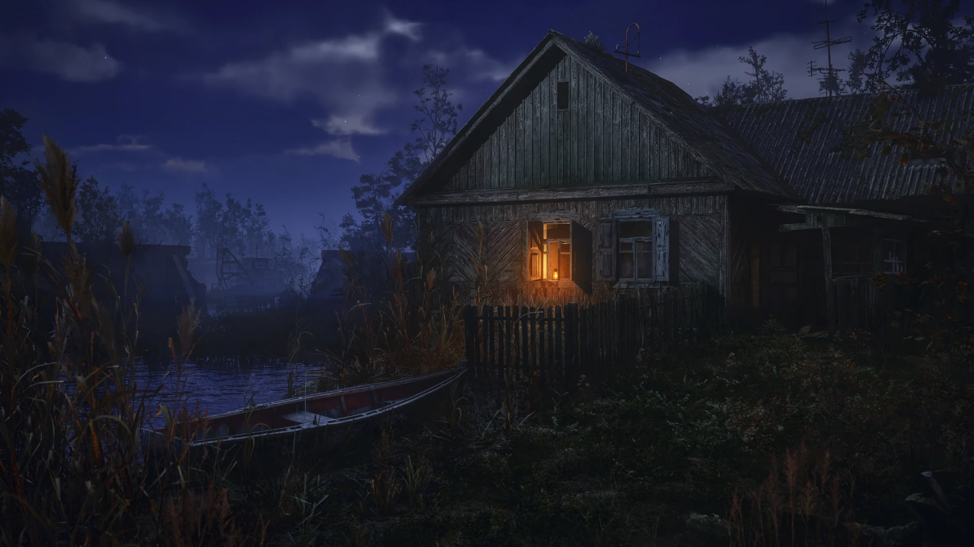 A wooden village house at night beside still water, one window lit orange from within, with a small boat moored among tall reeds under a clouded blue sky.